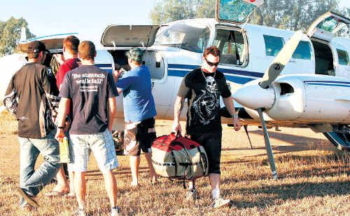 Grasstree Mine FIFOs collect their gear after landing near Capella on a chartered flight. Grasstree Mine FIFOs collect their gear after landing near Capella on a chartered flight.